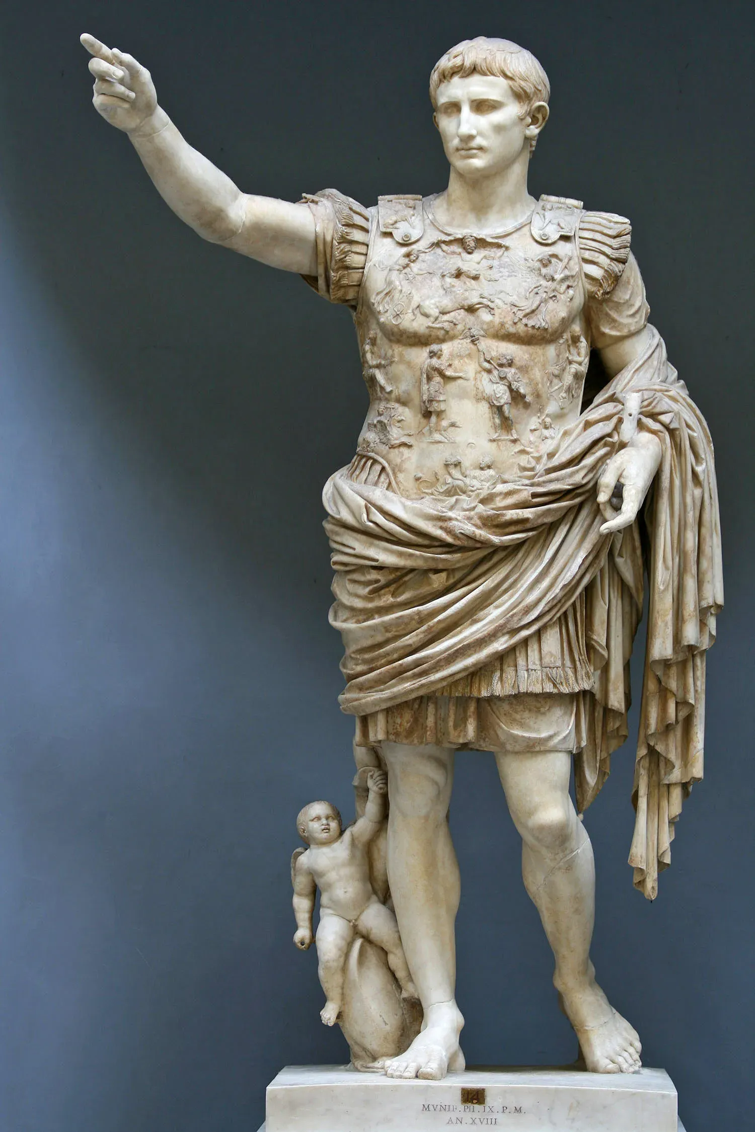 roman marble statue of augustus in cuirass, arm raised in a gesture of command