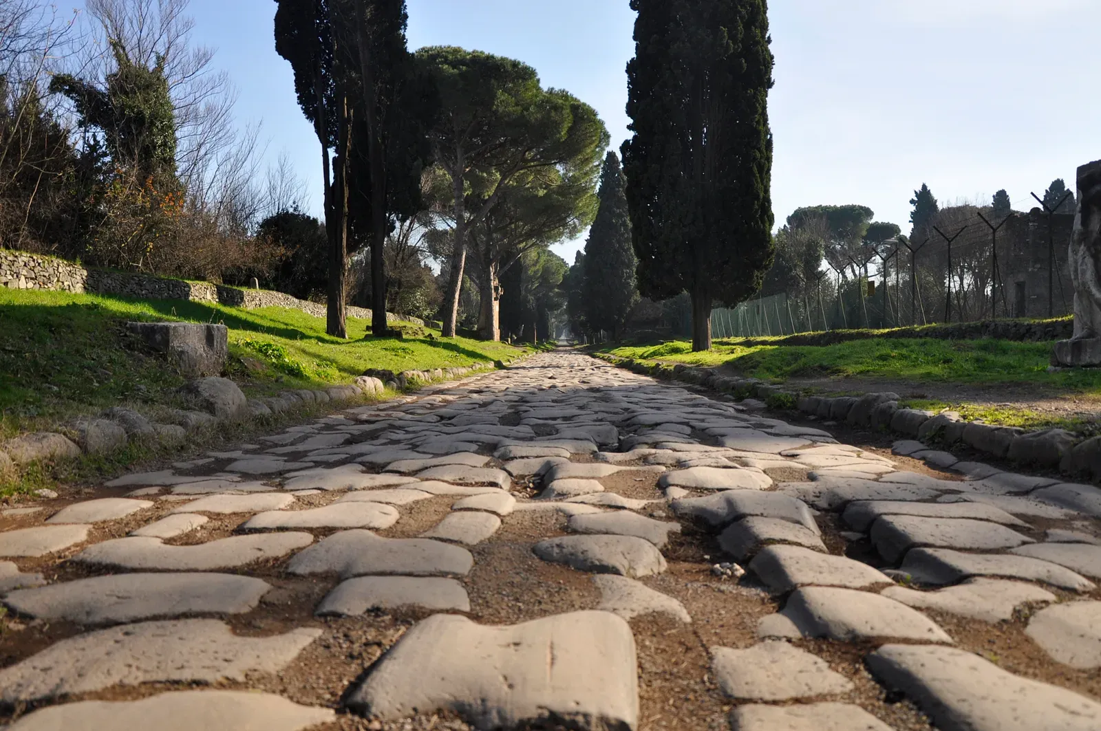 the stone-paved roadway of the ancient appian way outside rome